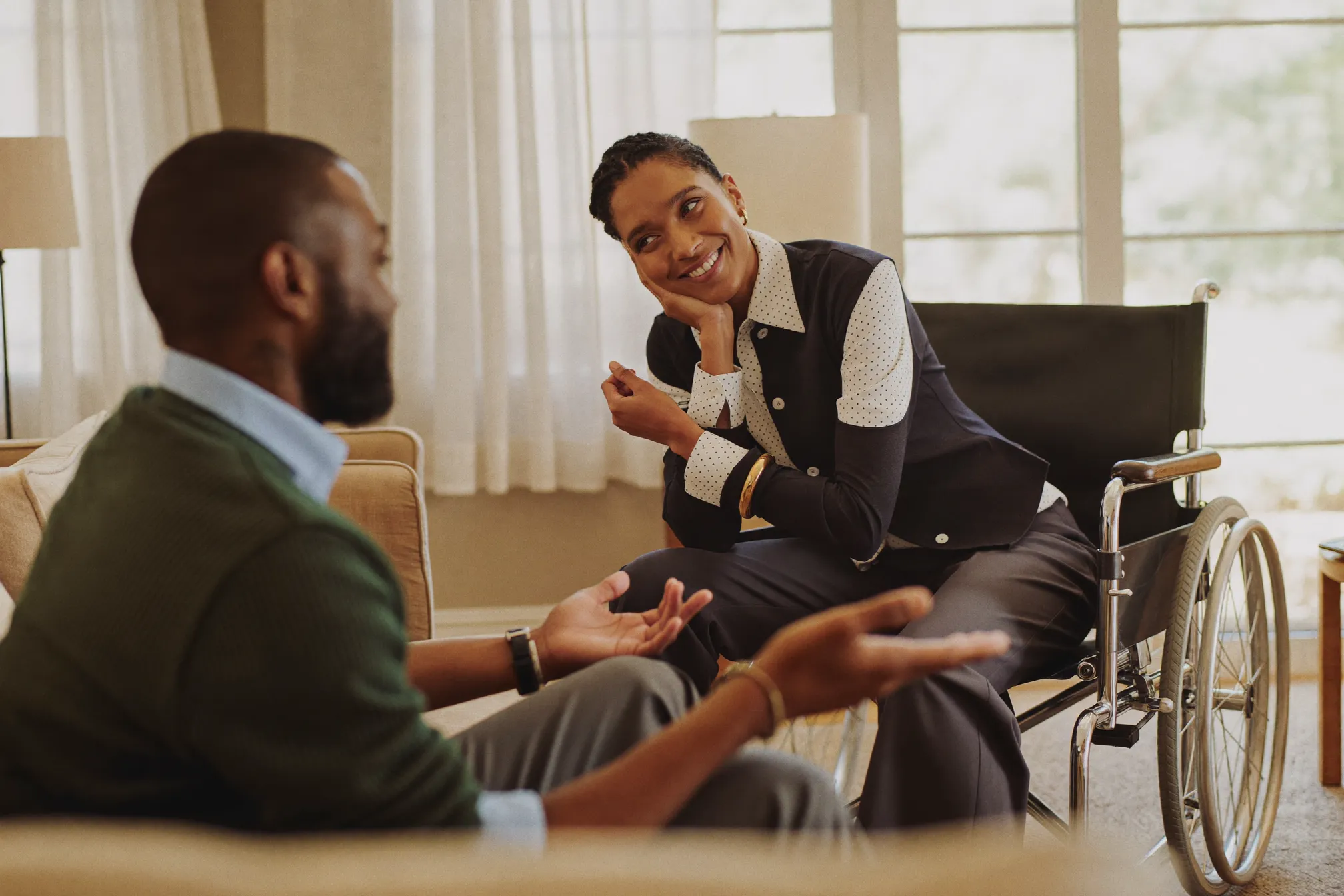 A support coordinator talking with a young adult during a home visit