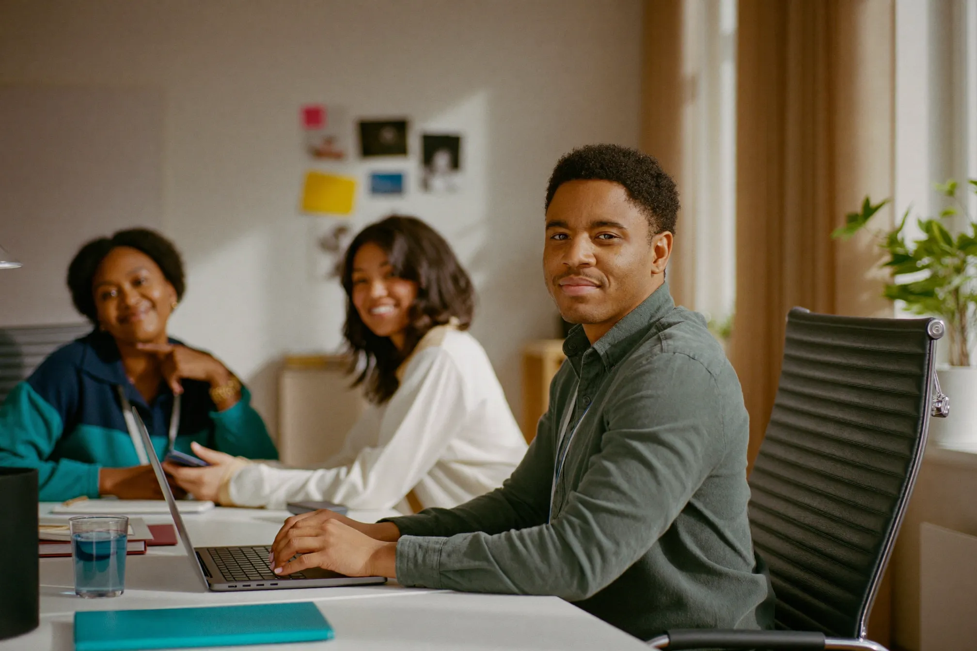 A care team collaborating around a laptop